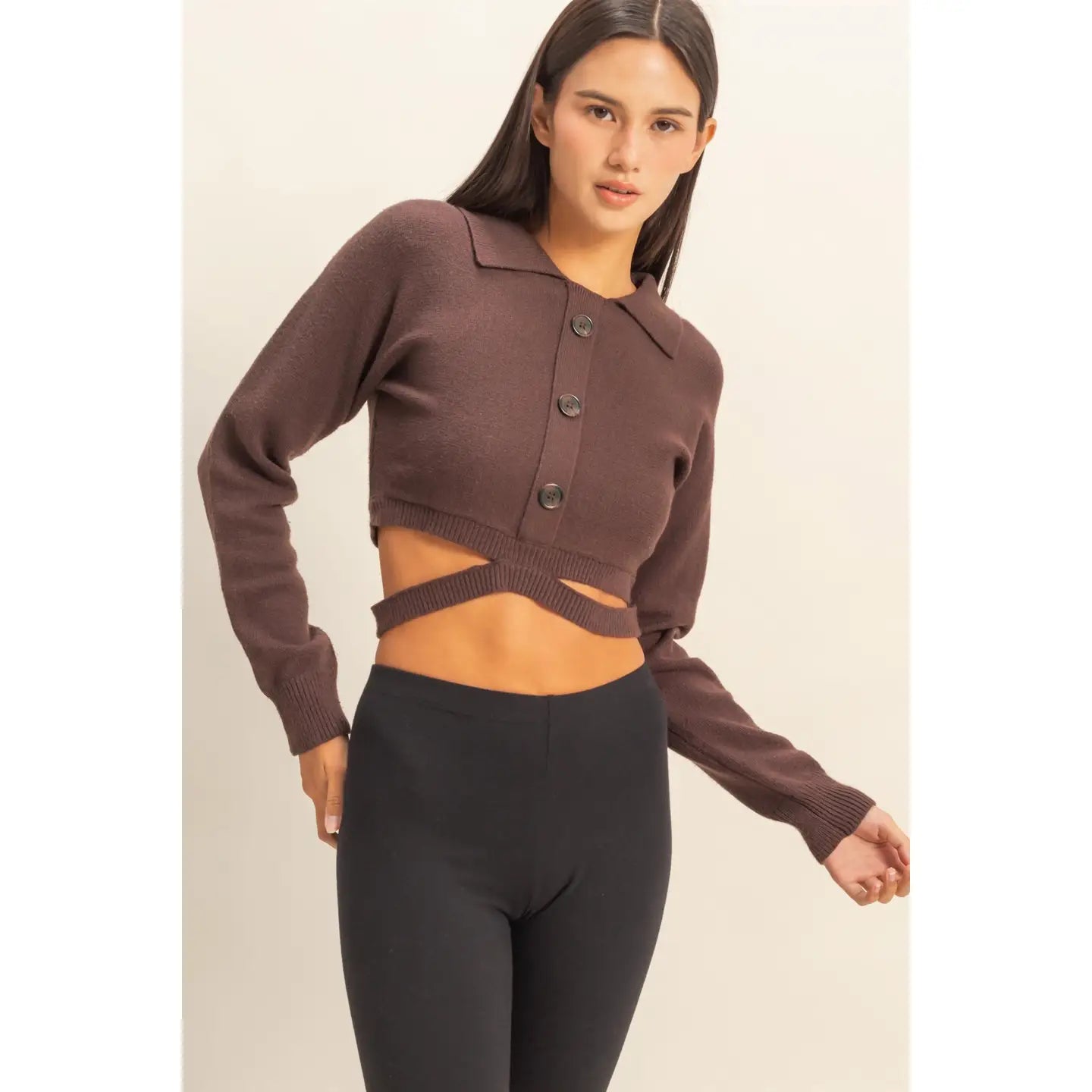 SEXY CROPPED CARDIGAN in Dark Chocolate worn with black leggings, featuring stylish buttons and a trendy cut-out design.