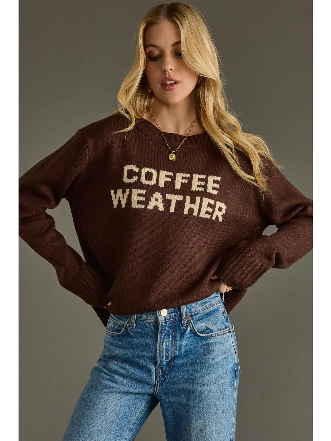 Coffee Weather Sweater in dark brown worn by a model with jeans.